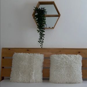 2 white shaggy pillows